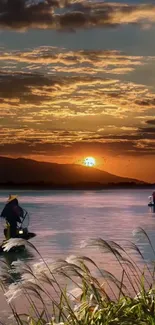 Serene sunset over a tranquil lake with fishermen and vibrant sky.