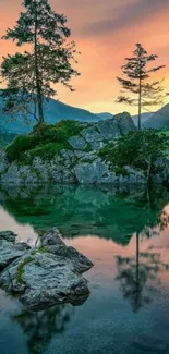 Serene lake at sunset with tree reflection.