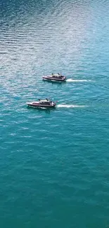 Two boats on a turquoise lake in a serene setting.