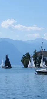 Sailboats floating on a serene lake with mountains in the background.