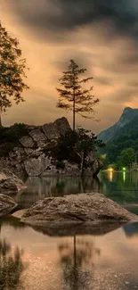 Lakeside at dusk with reflection and mountains silhouetted.