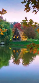 Lakeside cabin surrounded by autumn trees reflecting in still water.