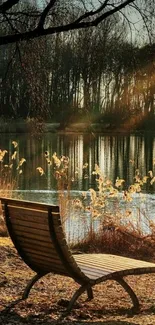 Wooden bench by a calm autumn lake under soft sunlight.