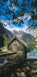 Serene lakeside cabin with mountain view and clear blue sky.