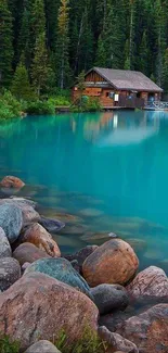 Serene lakeside cabin with turquoise waters and lush forest backdrop.