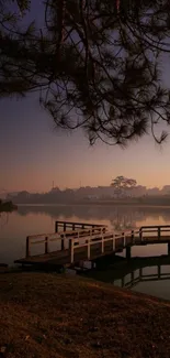 Serene dusk at a tranquil lakeside with silhouettes.