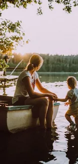 Mother and child at serene lakeside during sunset.