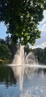 Serene lakeside scene with a fountain and lush greenery.