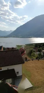 Serene view of lake and mountains under a sunny blue sky.