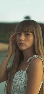 A serene portrait of a young woman by a lakeside at dusk.