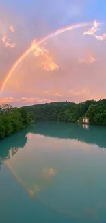 Lakeside with a rainbow and lush green surroundings in a serene setting.