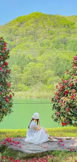 Woman in white dress by a serene lakeside with vibrant flowers and green hills.