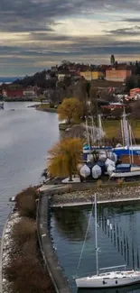 Lakeside town with sailboats and tranquil scenery.