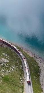 A train curves alongside a serene, blue lakeside.