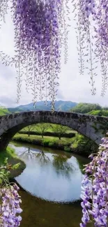 Stone bridge with lavender flowers reflecting on a tranquil river.