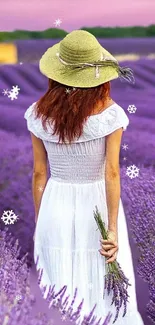 Woman in white dress walking through a lavender field with a pink sky.