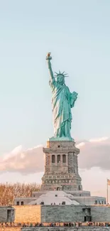 Statue of Liberty at sunset with clear skies.