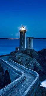 Peaceful lighthouse at dusk with deep blue ocean.