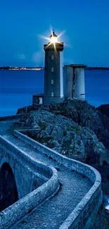 Lighthouse at night with ocean view.