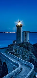 Serene lighthouse with ocean view and starry sky.