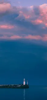 Lighthouse against a vibrant sunset sky with purple and pink clouds over the ocean.