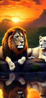 Two lions resting by a serene lake at sunset.