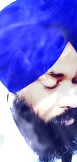 Serene man wearing a blue turban with peaceful expression, close-up portrait.