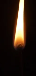 Mobile wallpaper featuring a glowing match flame against a dark background.