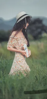 A woman wearing a floral dress walking through a green meadow.