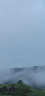 Misty hills under a serene blue sky.