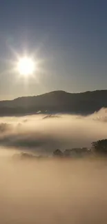 Serene sunrise over misty mountains with a bright sky.