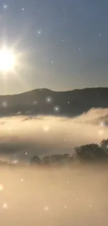 Scenic misty sunrise over mountains with sunlight breaking through fog.