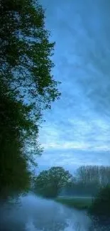 Serene misty river with blue sky and trees.