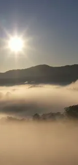 Sunrise over misty hills and foggy landscape.