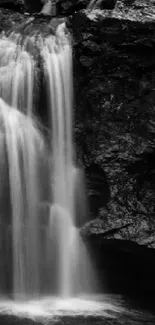 Black and white wallpaper of a serene waterfall cascading over rocky cliffs.