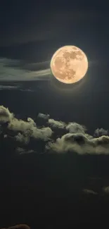 Full moon illuminating a dark night sky with scattered clouds.