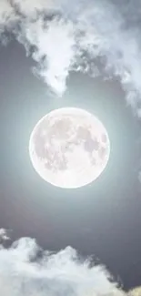 Full moon surrounded by clouds on a blue-gray night sky.