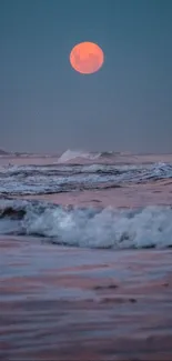 Full moon casting light over calm ocean waves.