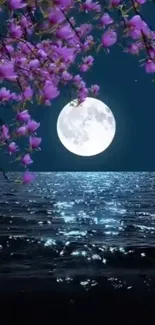 Moonlit ocean with blossoms under a night sky.