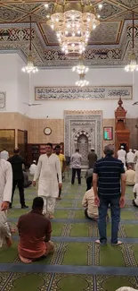 Interior view of a mosque with people gathered for prayer.