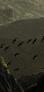 Mountain landscape with birds flying in a serene, olive green setting.