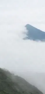 Misty mountain with clouds covering the peaks.