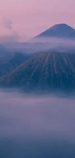 Serene wallpaper with misty purple mountains and foggy atmosphere.