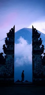 Mobile wallpaper of a person at a mountain gate at dawn.