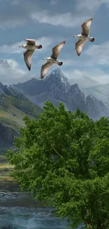 Geese flying over lush green mountains with a vibrant tree in foreground.