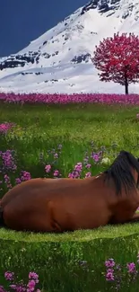 Horse resting in a vibrant meadow with mountains and a cherry tree.