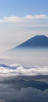 Mountain silhouette with clouds and blue sky.