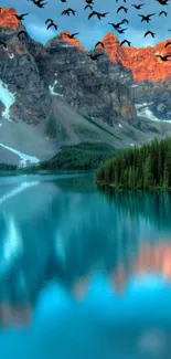 Mountain lake at sunrise with birds flying.