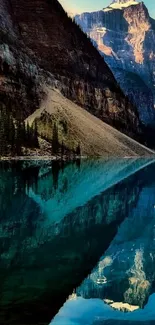 Reflection of mountains in a serene turquoise lake under a clear blue sky.