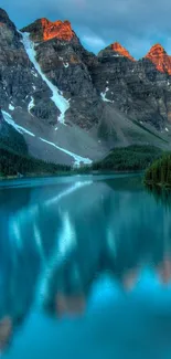 Serene mountain lake reflecting peaks under a clear sky in the wallpaper.